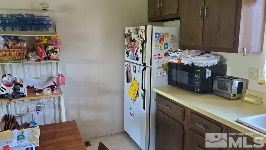 605 Lander Street Reno, NV 89509 - Photo 6 of 17 a utility room with stainless steel appliances lots of clutter