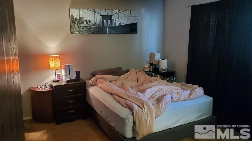 605 Lander Street Reno, NV 89509 - Photo 8 of 17 a bedroom with a bed and a chandelier