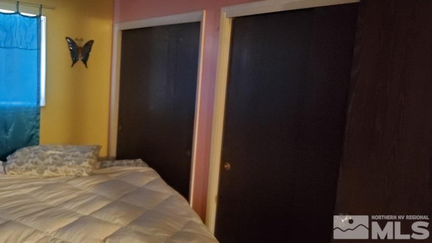 605 Lander Street Reno, NV 89509 - Photo 9 of 17 a bedroom with a bed and wooden floor