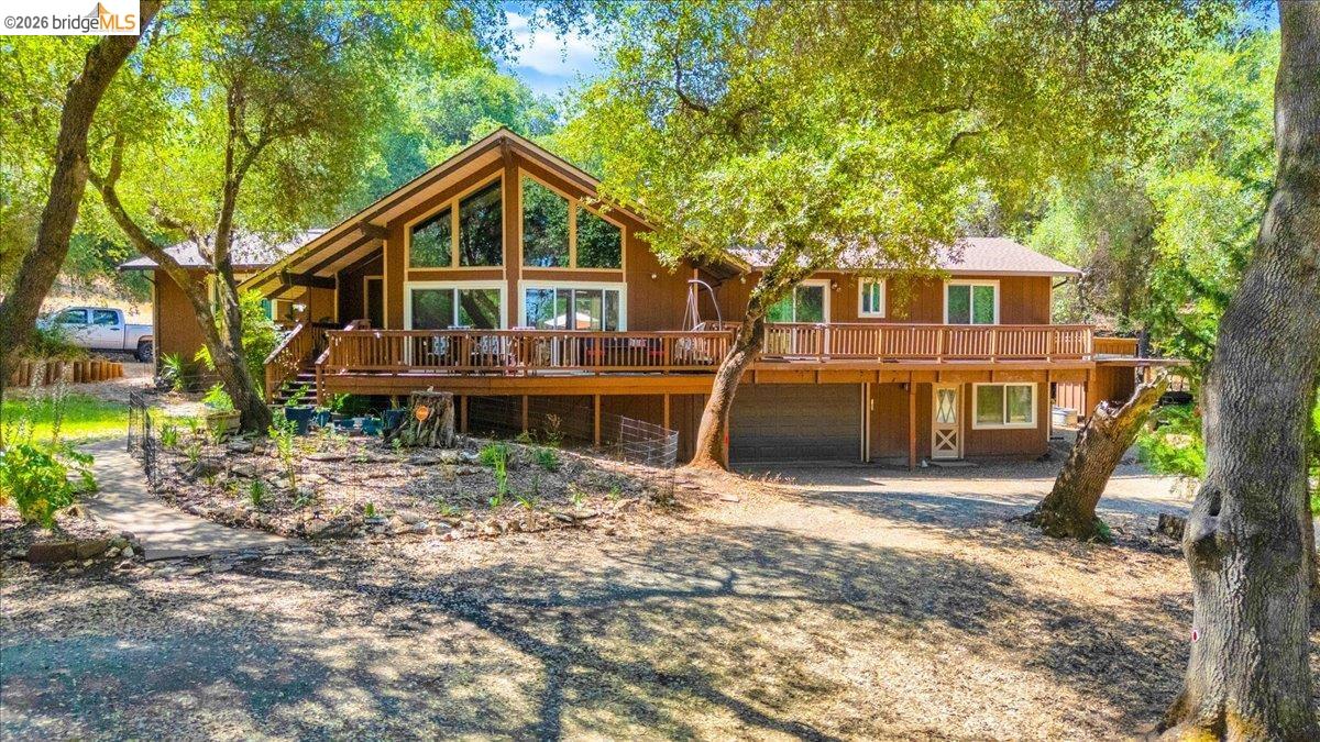 8733 Fraguero Road Sonora, CA 95370 - Photo 8 of 73 Front exterior featuring a multi-level deck, prominent A-frame window design, and a two-car garage