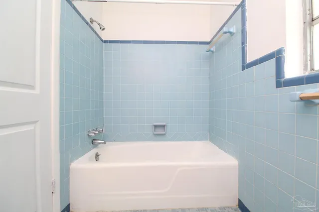 a white bath tub sitting in a bathroom