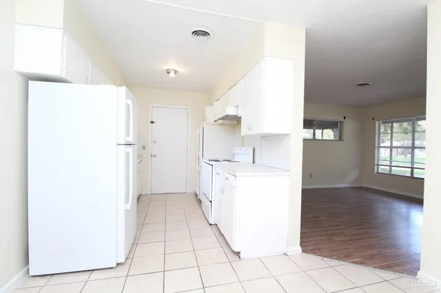 a utility room with cabinets washer and dryer