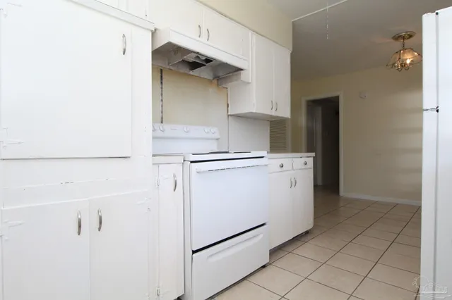 a utility room with cabinets washer and dryer