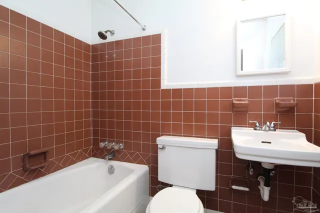 a bathroom with a sink a toilet and bathtub