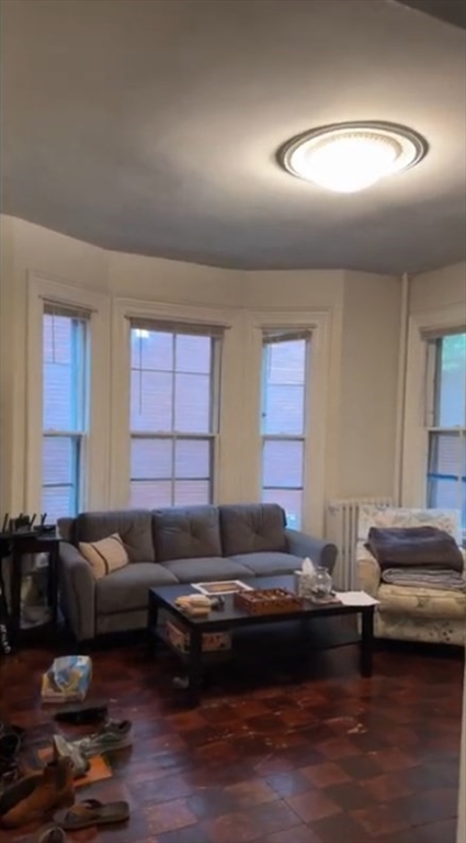 23 Inman Street, Unit 1 Cambridge, MA 02139 - Photo 1 of 20 a living room with a couch and a window