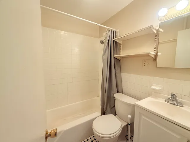 a bathroom with a toilet a sink and a shower