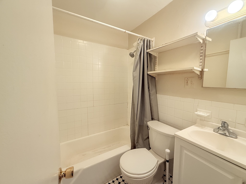 23 Inman Street, Unit 1 Cambridge, MA 02139 - Photo 12 of 20 a bathroom with a toilet a sink and a shower