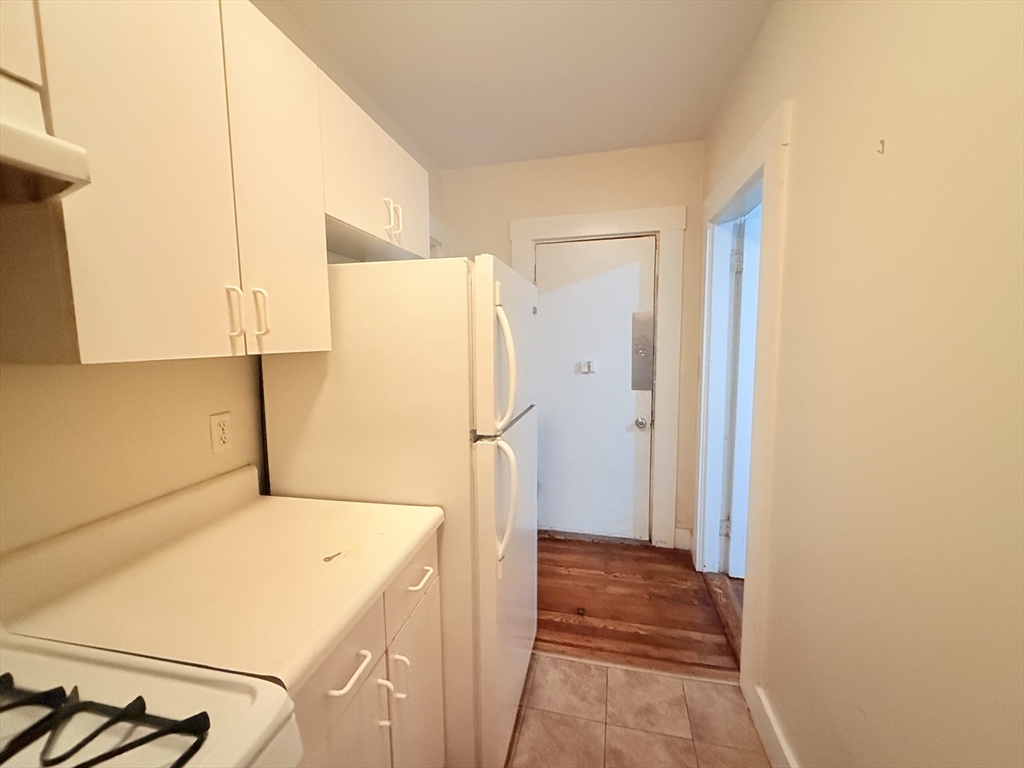 23 Inman Street, Unit 1 Cambridge, MA 02139 - Photo 14 of 20 a view of a storage & utility room with refrigerator