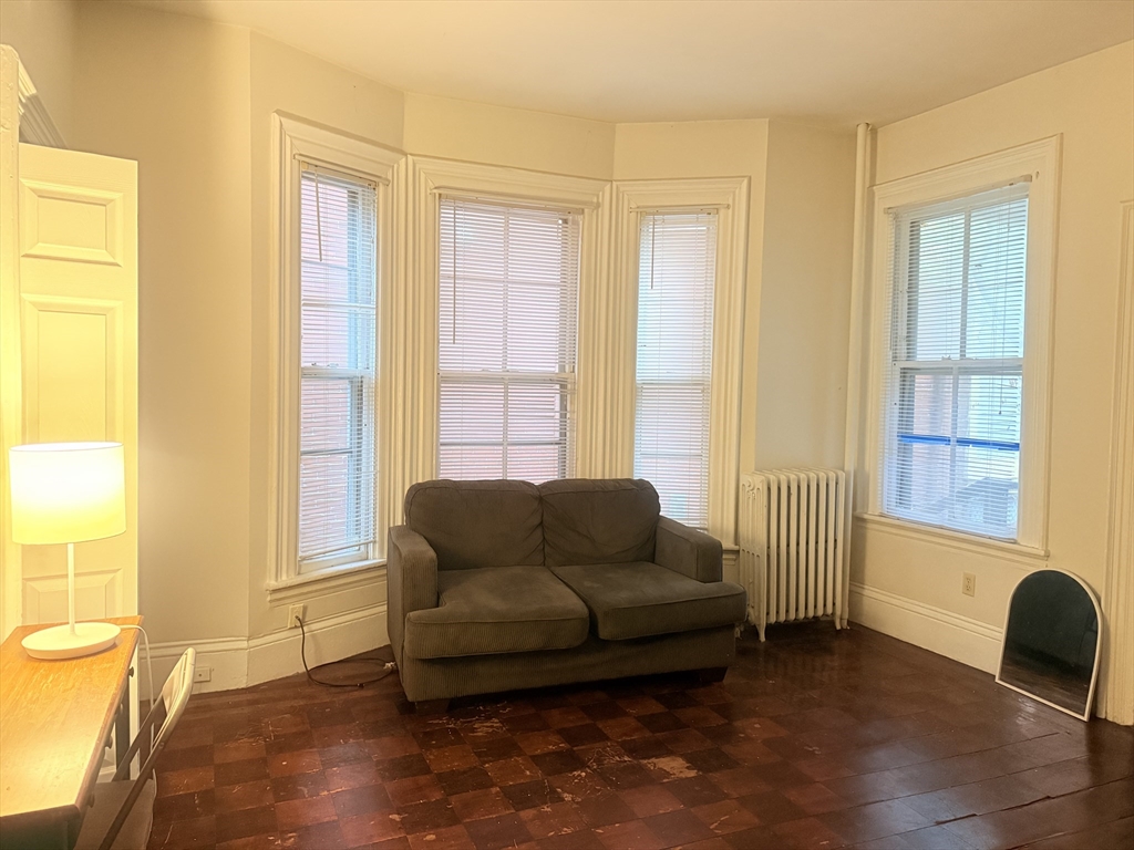 23 Inman Street, Unit 1 Cambridge, MA 02139 - Photo 18 of 20 a living room with furniture and a window