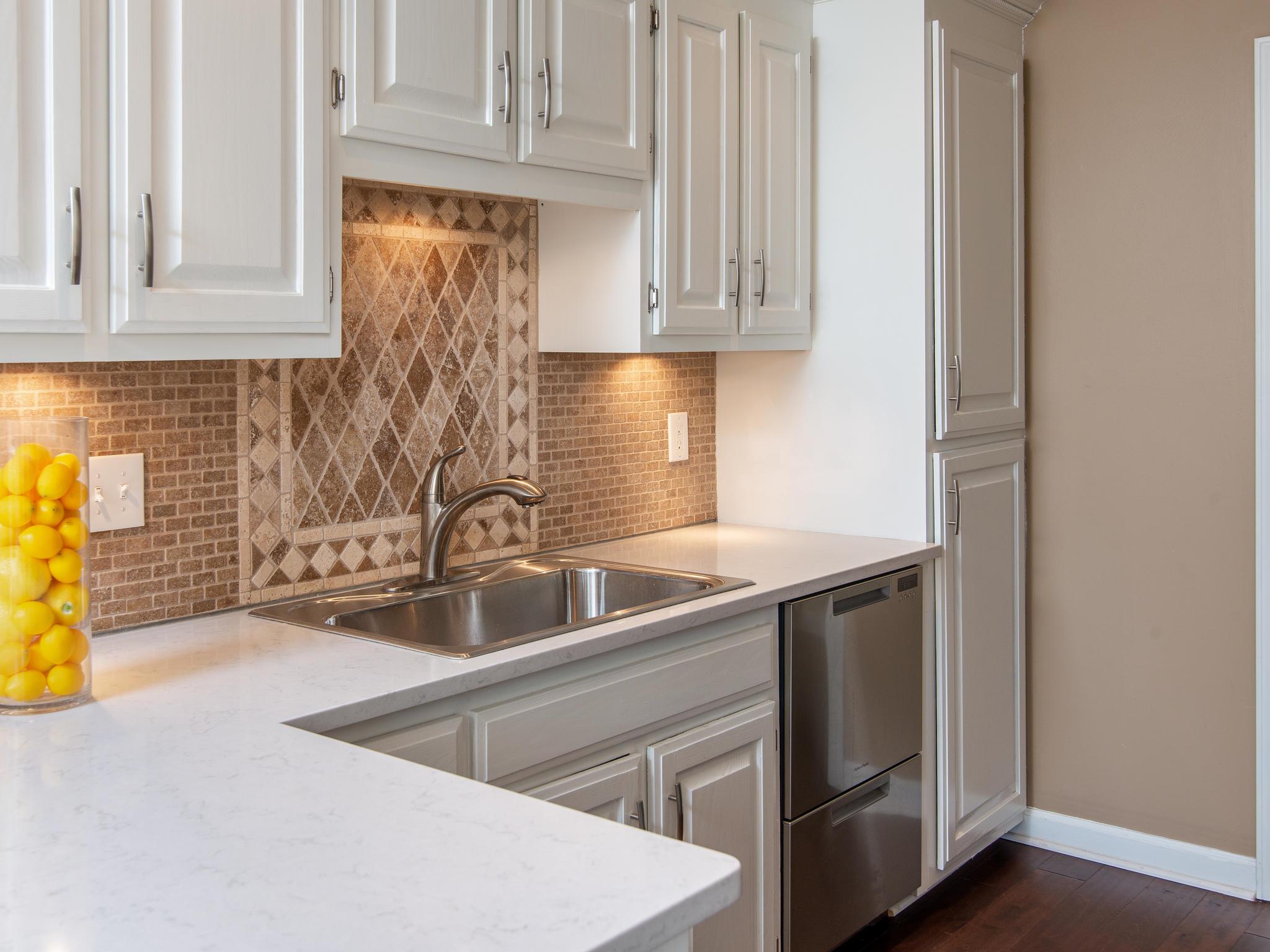 732 General George Patton Road, Unit 732 Nashville, TN 37221 - Photo 15 of 27 a kitchen with stainless steel appliances granite countertop a sink and dishwasher with wooden floor