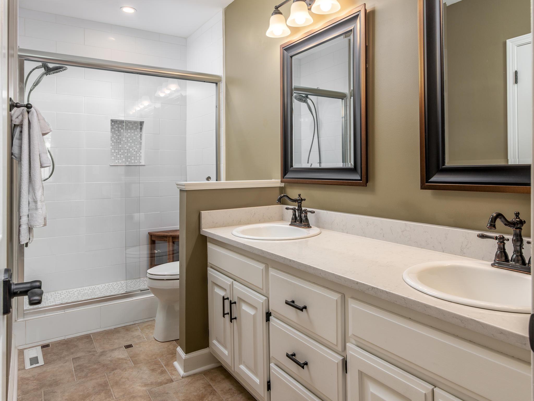 732 General George Patton Road, Unit 732 Nashville, TN 37221 - Photo 18 of 27 a bathroom with a sink double vanity granite toilet and a tub
