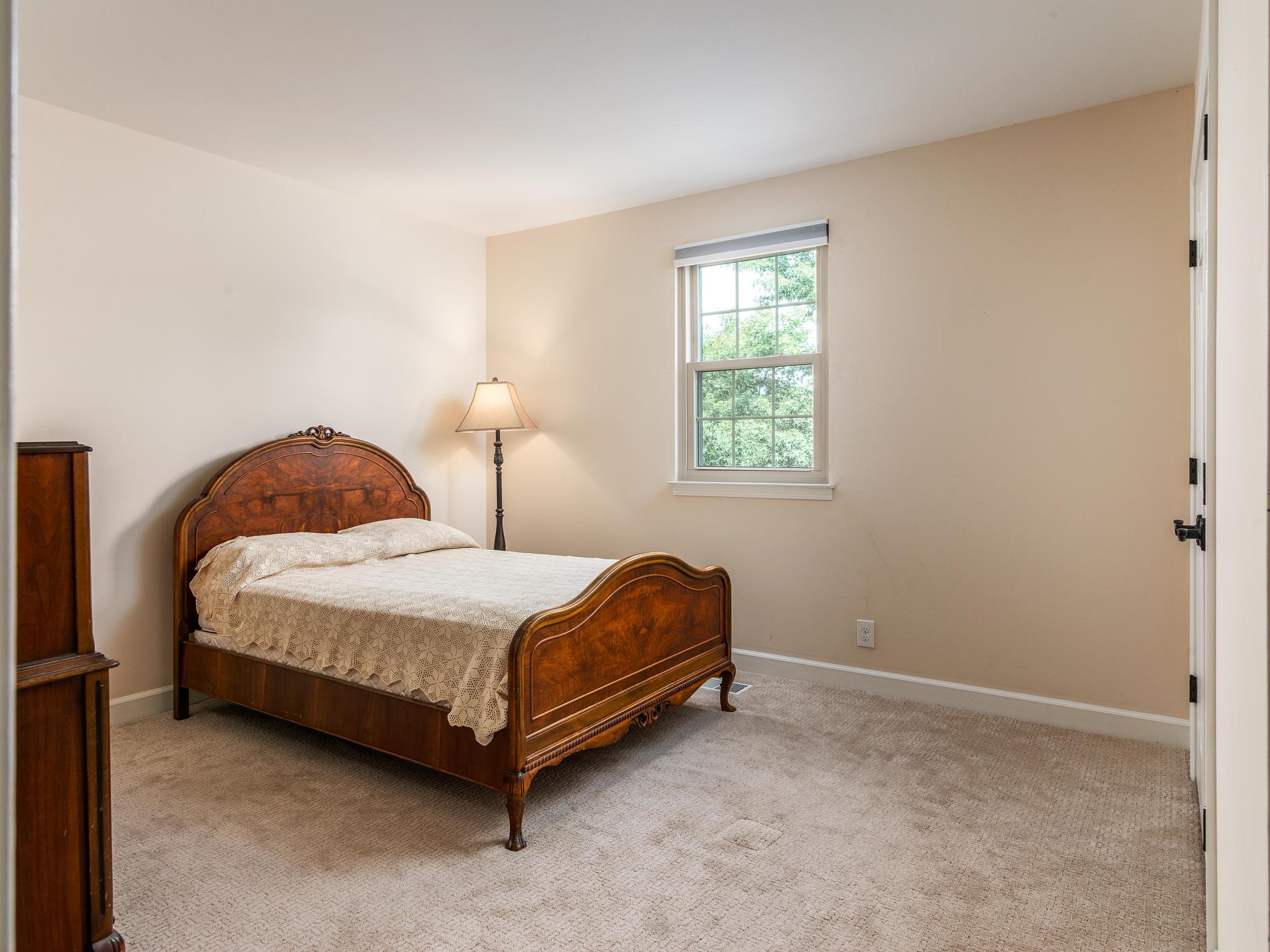 732 General George Patton Road, Unit 732 Nashville, TN 37221 - Photo 20 of 27 a bedroom with a bed lamp and window