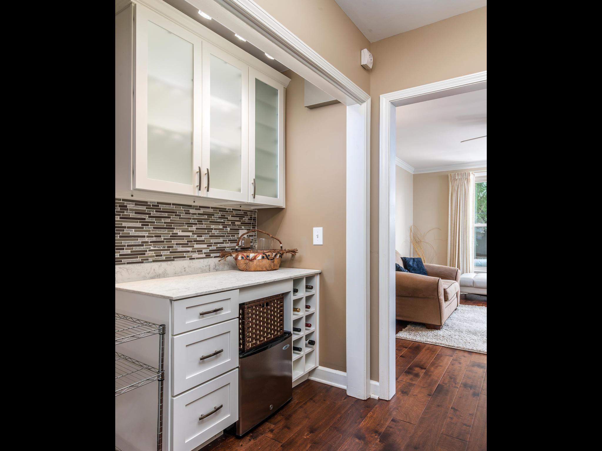 732 General George Patton Road, Unit 732 Nashville, TN 37221 - Photo 7 of 27 a view of living room with granite countertop furniture a fireplace and wooden floor