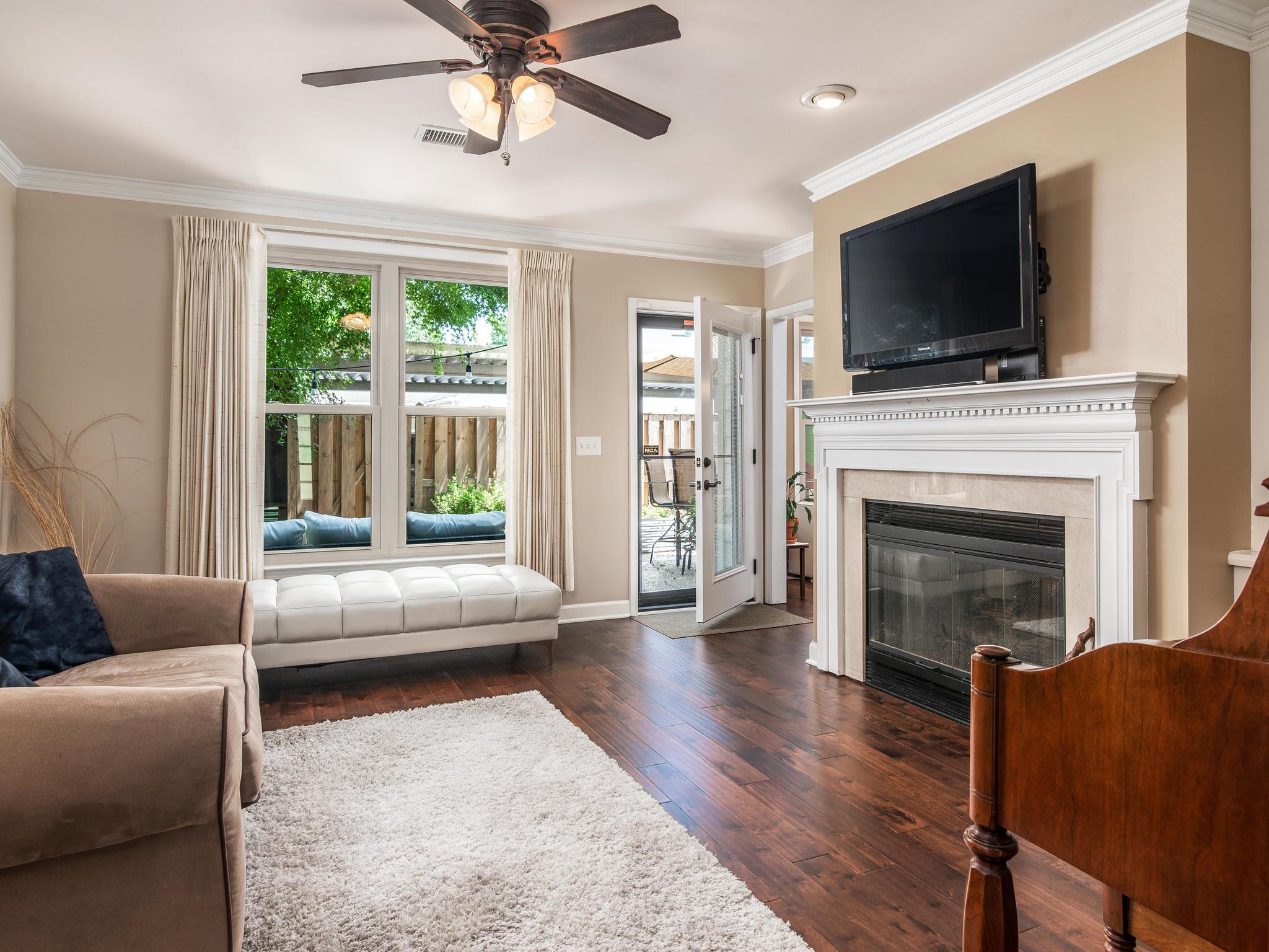 732 General George Patton Road, Unit 732 Nashville, TN 37221 - Photo 9 of 27 a living room with furniture a flat screen tv and a fireplace