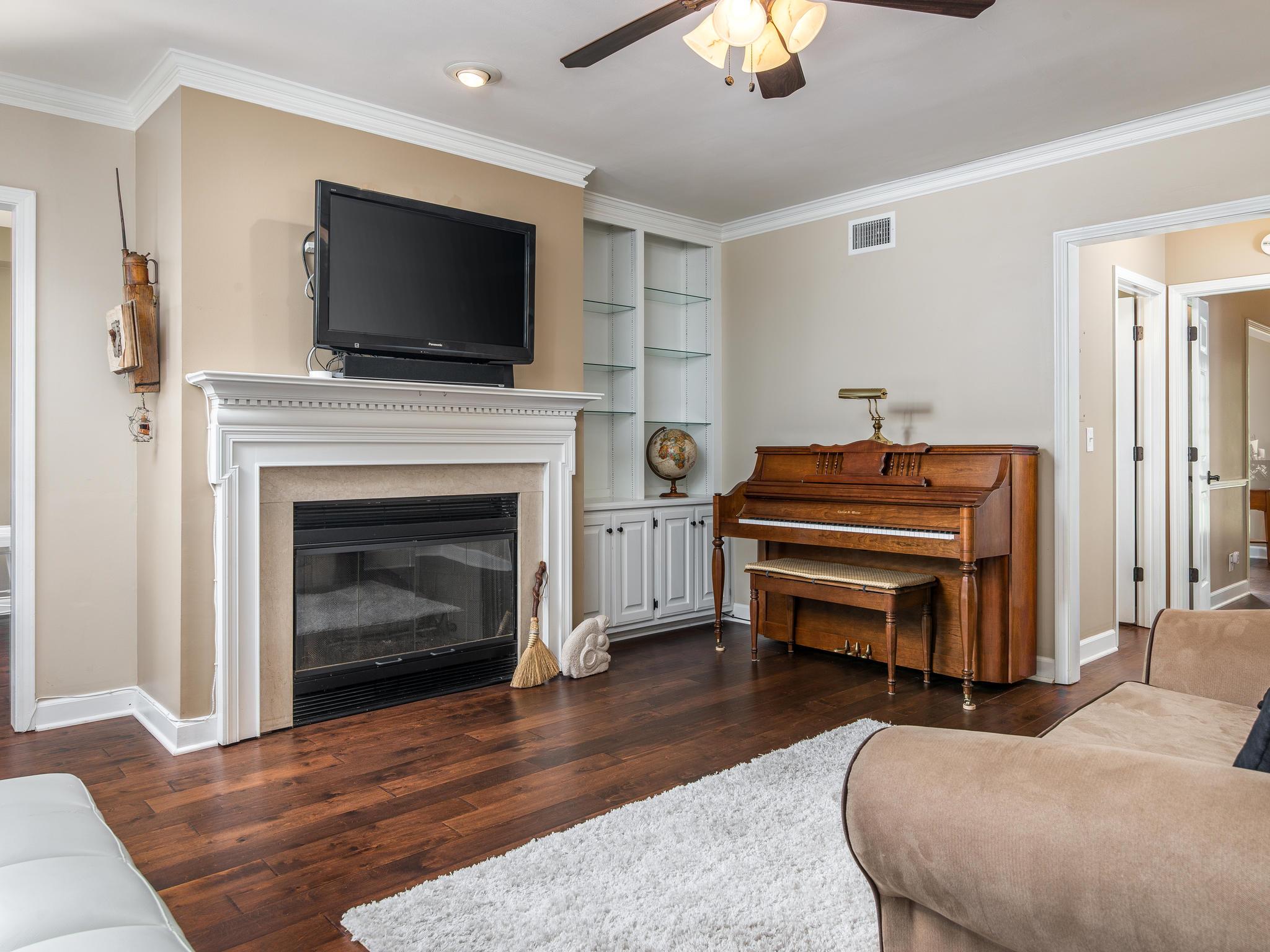 732 General George Patton Road, Unit 732 Nashville, TN 37221 - Photo 10 of 27 a bedroom with furniture and a fireplace