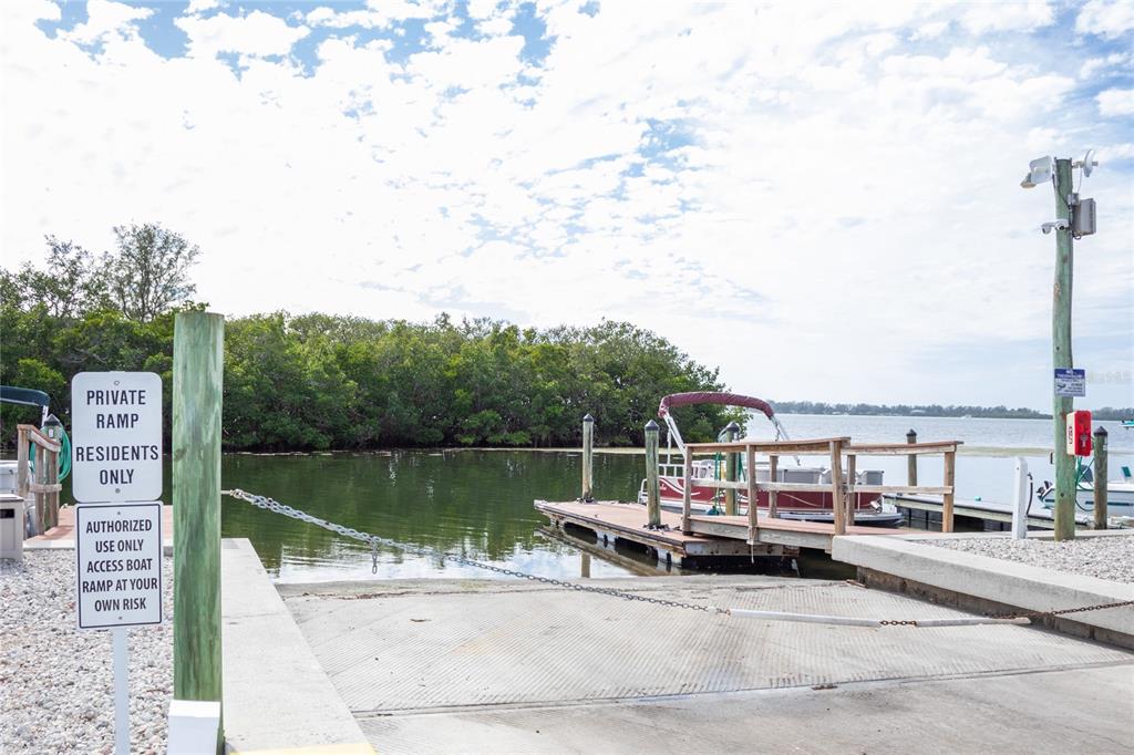 10315 Cortez Road West, Unit 11B Bradenton, FL 34210 - Photo 17 of 27 a view of a lake with a bench next to a lake