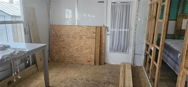 a view of a room that has a bed and a window