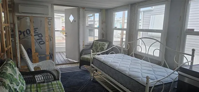 a bedroom with a bed and large window