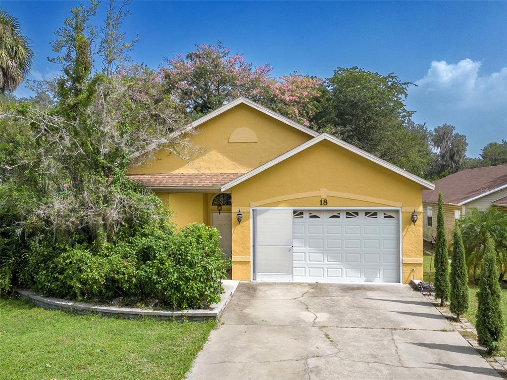 18 Ginger Circle Leesburg, FL 34748 - Photo 1 of 1 a view of a house with a yard and potted plants