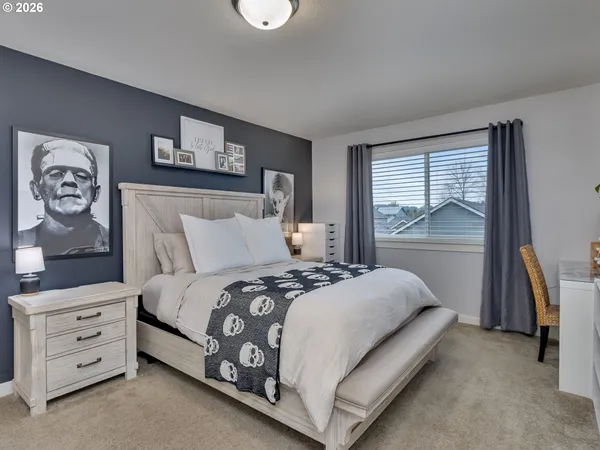 a bedroom with a bed and a window