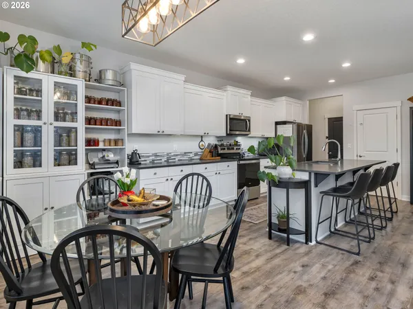 a view of a dining room with furniture and a kitchen