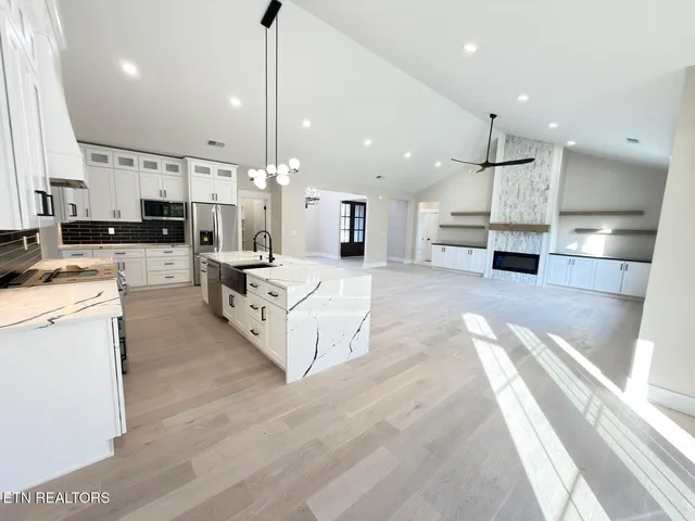 a kitchen with stainless steel appliances sink and stove