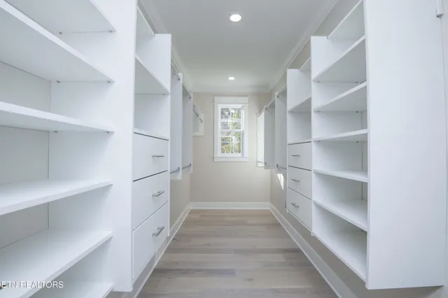 an empty room with window and ceiling fan