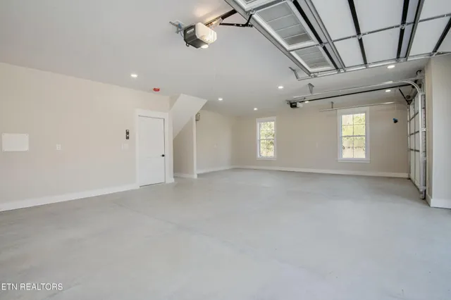 a view of a house with a big yard and large trees