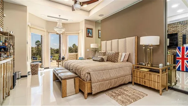 a bedroom with a bed a couch and a large window