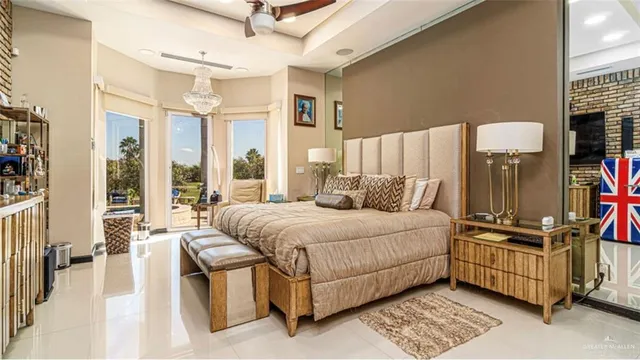 a bedroom with a bed a couch and a large window