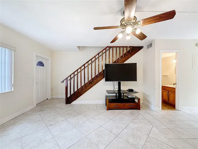 a living room with furniture and a mirror