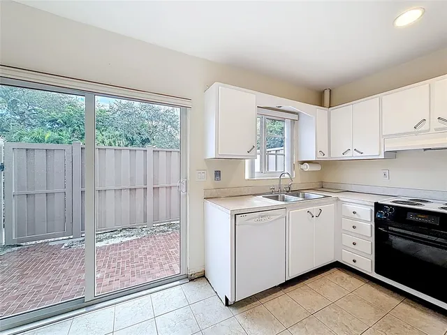 a kitchen that has a sink and a stove in it