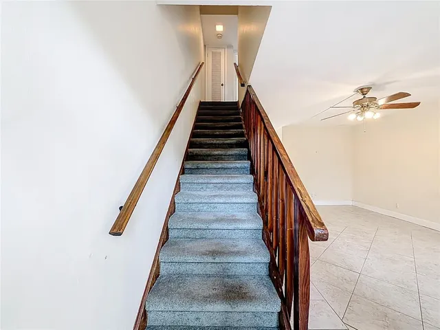 an empty room with closet and a chandelier fan