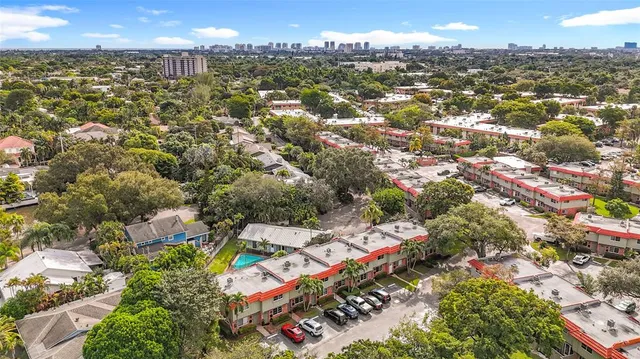 an aerial view of residential houses with outdoor space and swimming pool