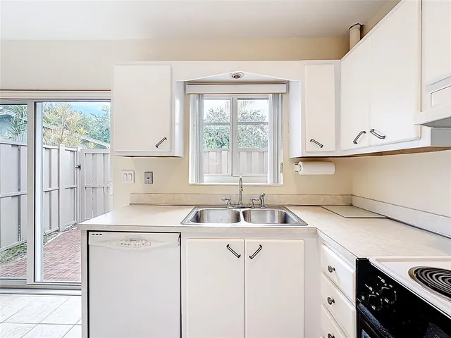 a utility room with sink dryer and washer