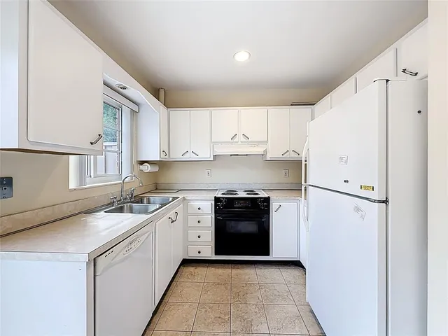 a kitchen with stainless steel appliances granite countertop a refrigerator sink and cabinets