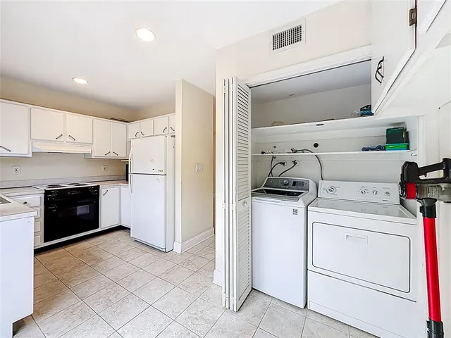 a kitchen with a stove top oven and refrigerator
