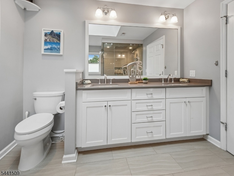 610 River Road Chatham, NJ 07928 - Photo 17 of 42 a bathroom with a granite countertop toilet sink and mirror