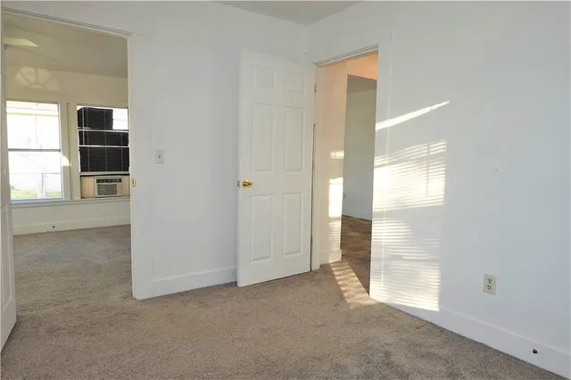 a view of an empty room and a window