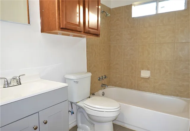 a view of a kitchen with white cabinets and stainless steel appliances