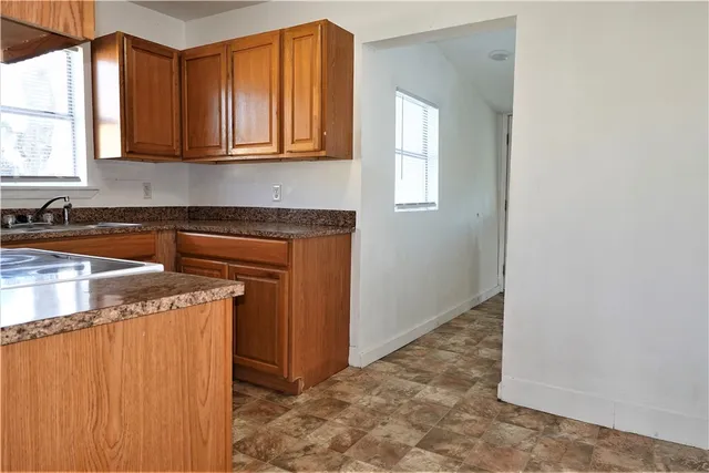 a view of a kitchen with stainless steel appliances granite countertop cabinets and a granite counter tops