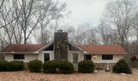 a house that has a tree in front of it