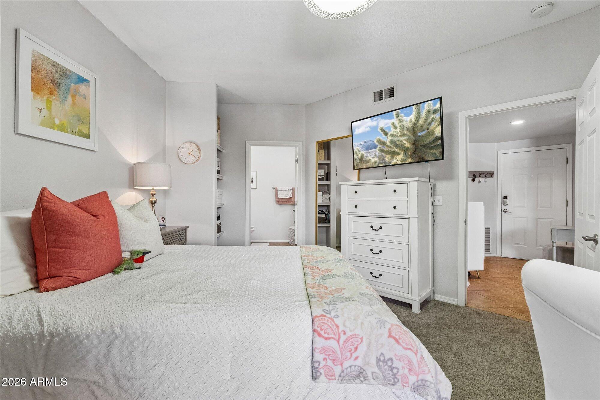 10030 West Indian School Road, Unit 269 Phoenix, AZ 85037 - Photo 10 of 29 a bedroom with a bed and a flat screen tv