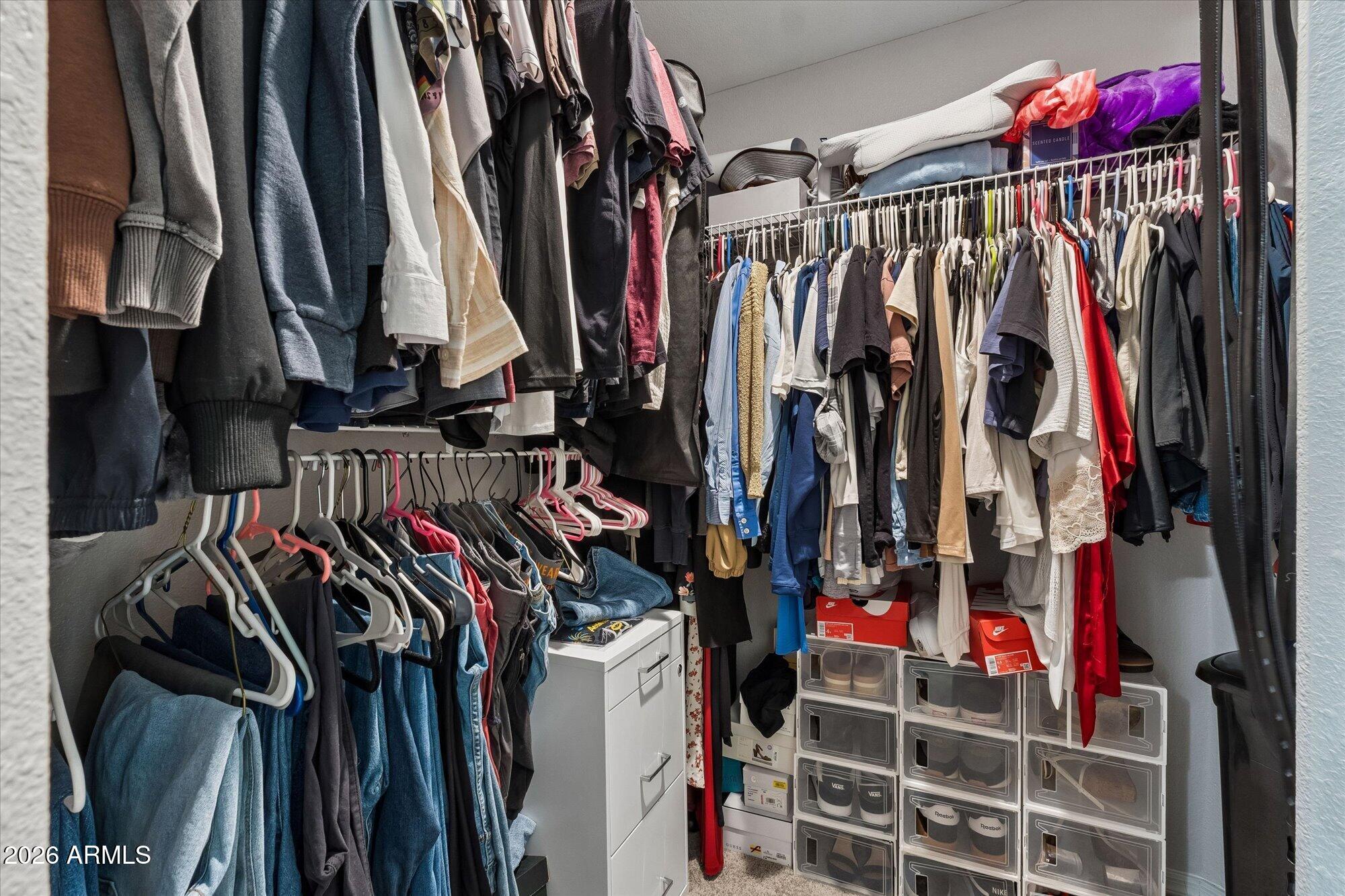 10030 West Indian School Road, Unit 269 Phoenix, AZ 85037 - Photo 11 of 29 a view of walk in closet with clothes
