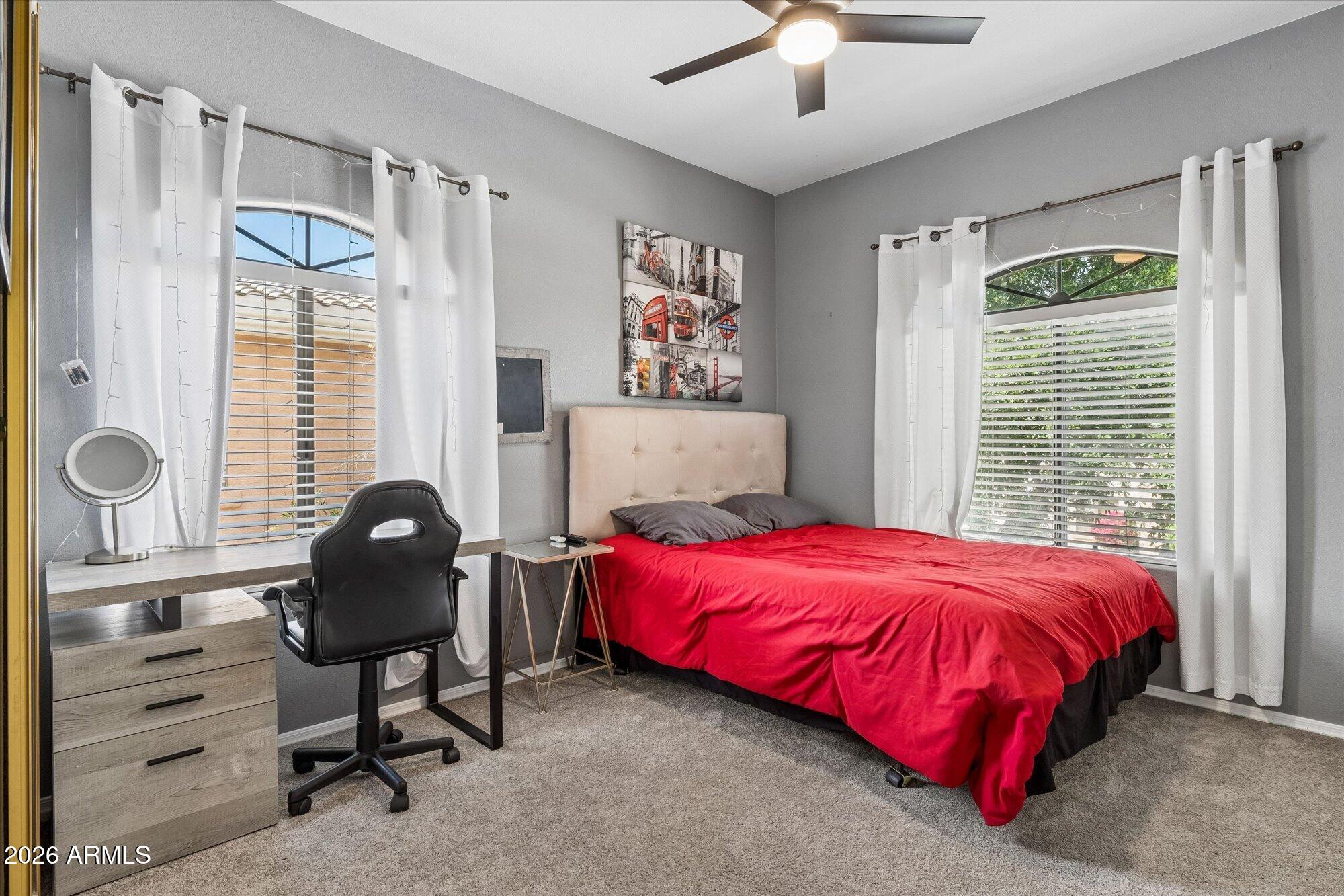 10030 West Indian School Road, Unit 269 Phoenix, AZ 85037 - Photo 14 of 29 a bedroom with a bed and a chandelier