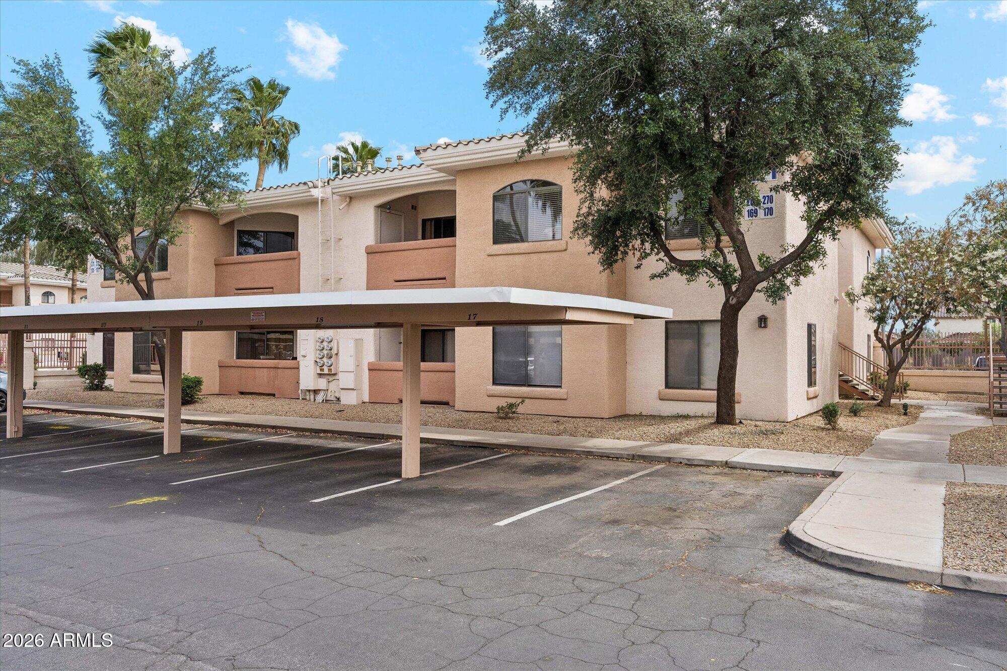10030 West Indian School Road, Unit 269 Phoenix, AZ 85037 - Photo 19 of 29 a front view of a house with a yard