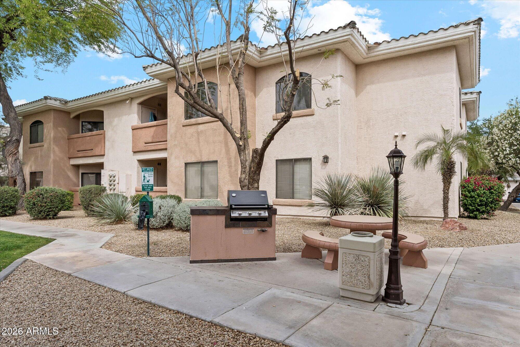 10030 West Indian School Road, Unit 269 Phoenix, AZ 85037 - Photo 23 of 29 a view of a patio with couches table and chairs and potted plants