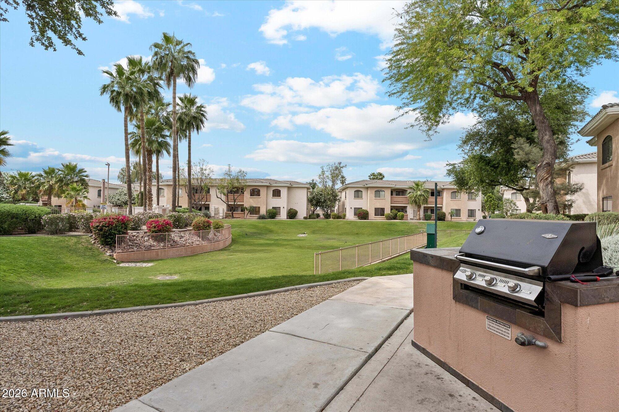 10030 West Indian School Road, Unit 269 Phoenix, AZ 85037 - Photo 24 of 29 a view of a garden with a house
