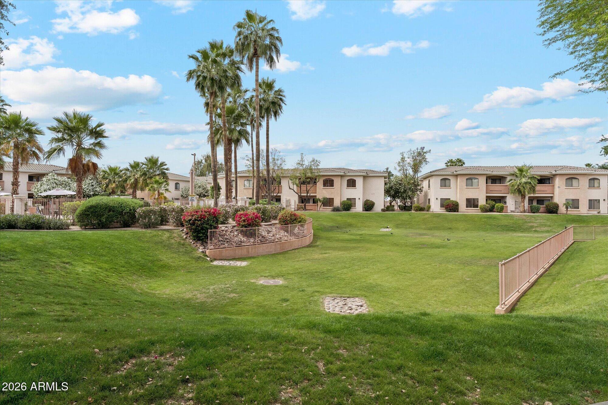 10030 West Indian School Road, Unit 269 Phoenix, AZ 85037 - Photo 25 of 29 a view of a house with a big yard and potted plants