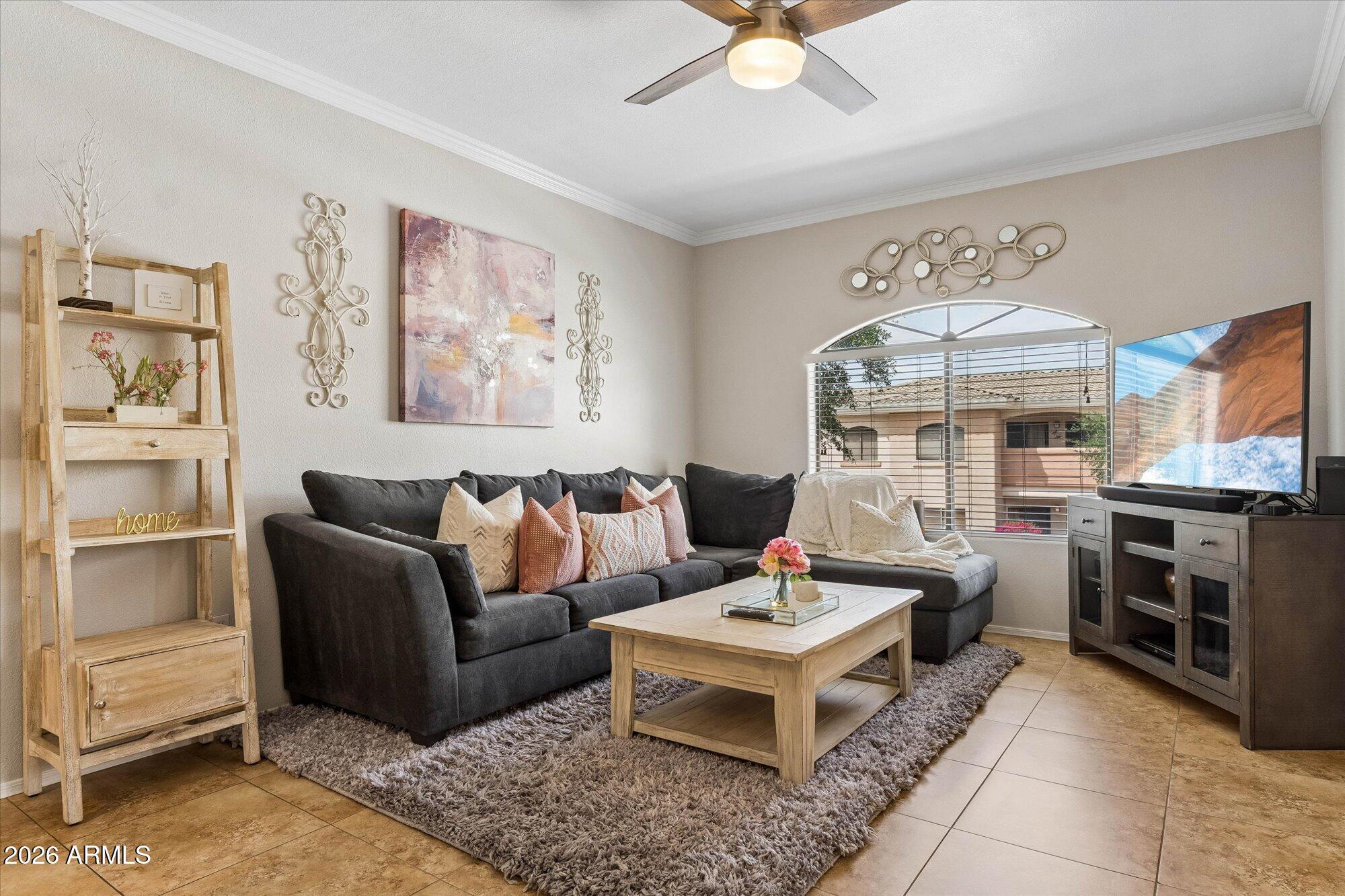 10030 West Indian School Road, Unit 269 Phoenix, AZ 85037 - Photo 6 of 29 a living room with furniture a flat screen tv and a fireplace